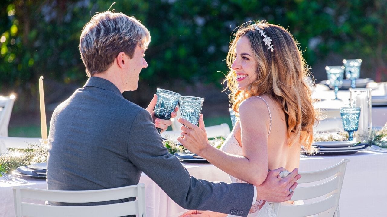 Bride and groom clinking glasses