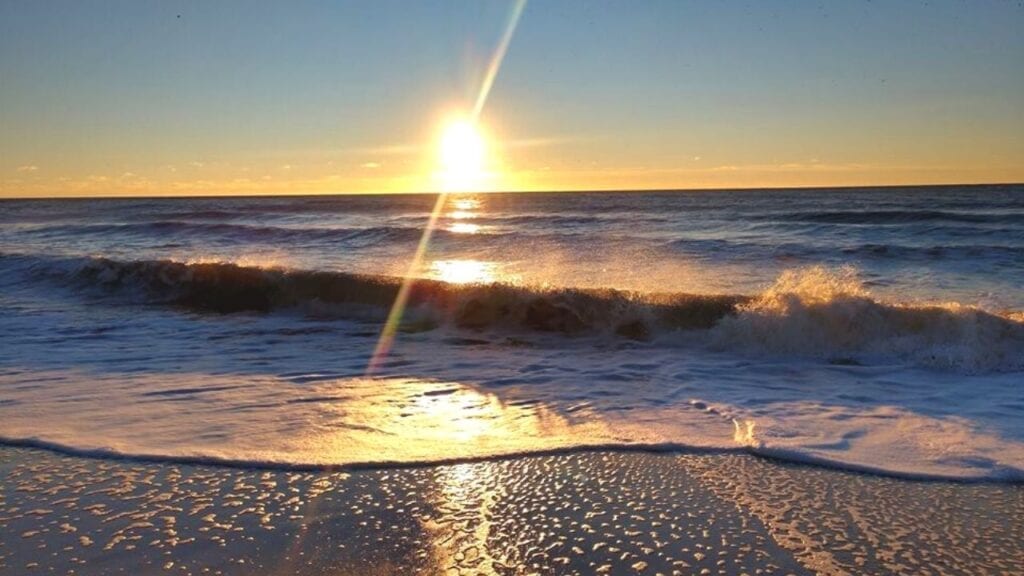 Sunrise over the ocean waves