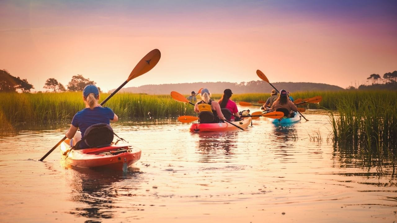 Family kayaking on the marsh