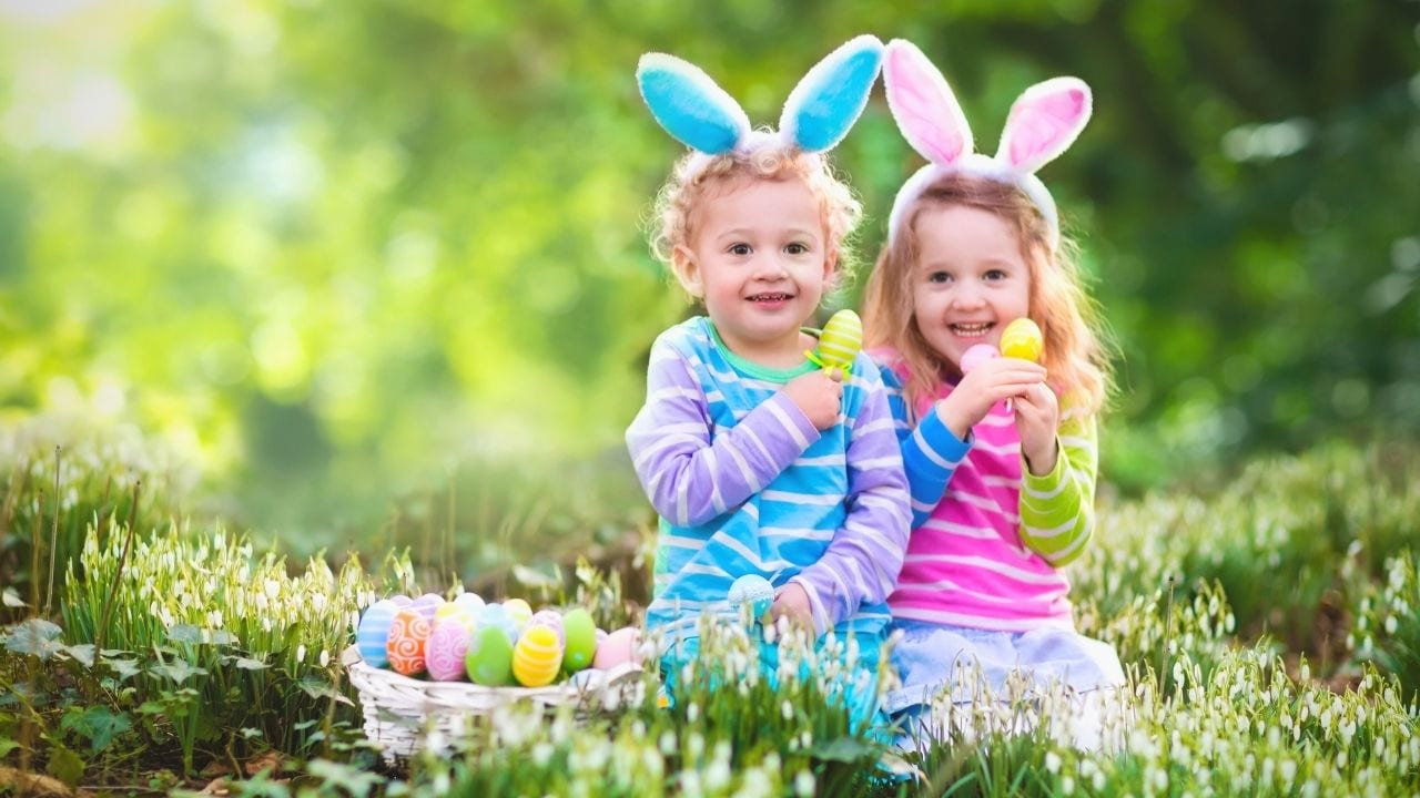 Little boy and girl holding Easter eggs