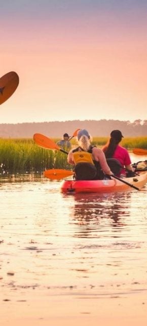 Family kayaking on the marsh